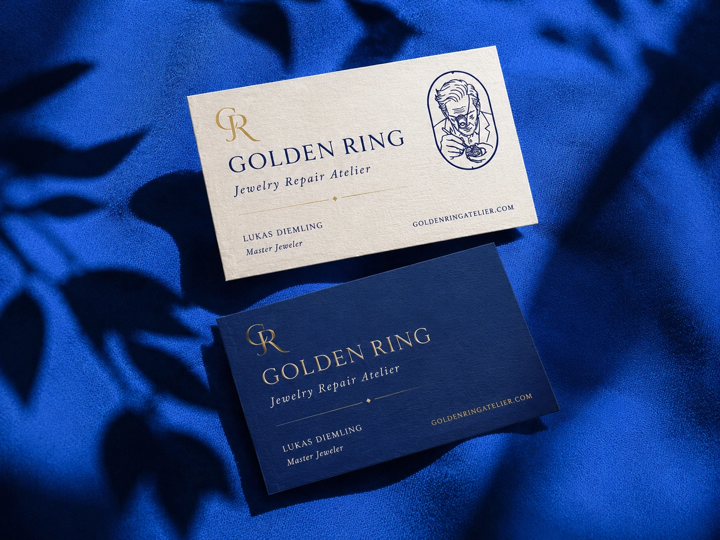 Golden Ring ivory and navy business cards on royal blue fabric