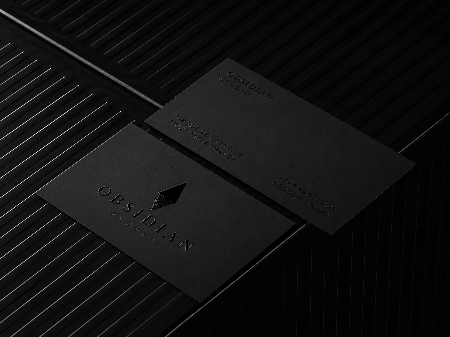 Obsidian editorial identity system with premium layout details